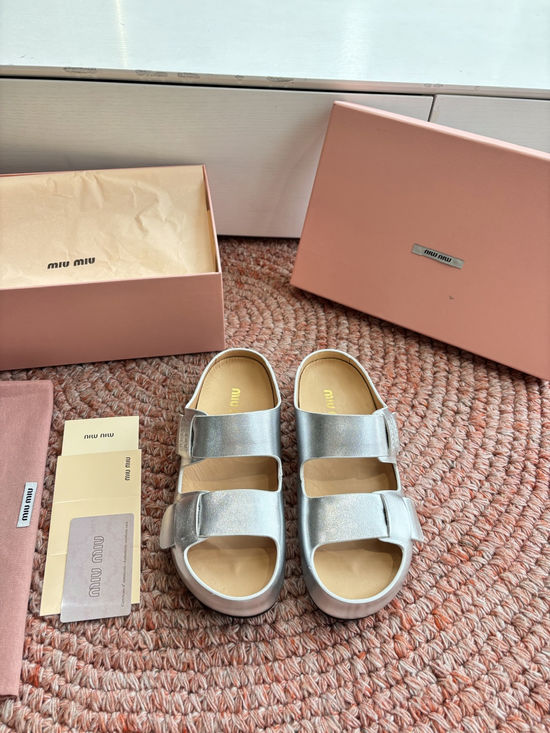 Miu Miu Soft Leather Slip On Sandals With Metal Emblem Detail