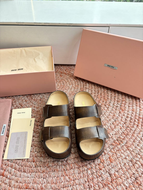 Miu Miu Soft Leather Slip On Sandals With Metal Emblem Detail