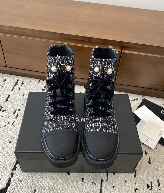 Chanel Elevated Leather Ankle Boots with Classic Fabric and Pearl Buttons